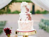 Handpainted wedding cake with rosette accent tier