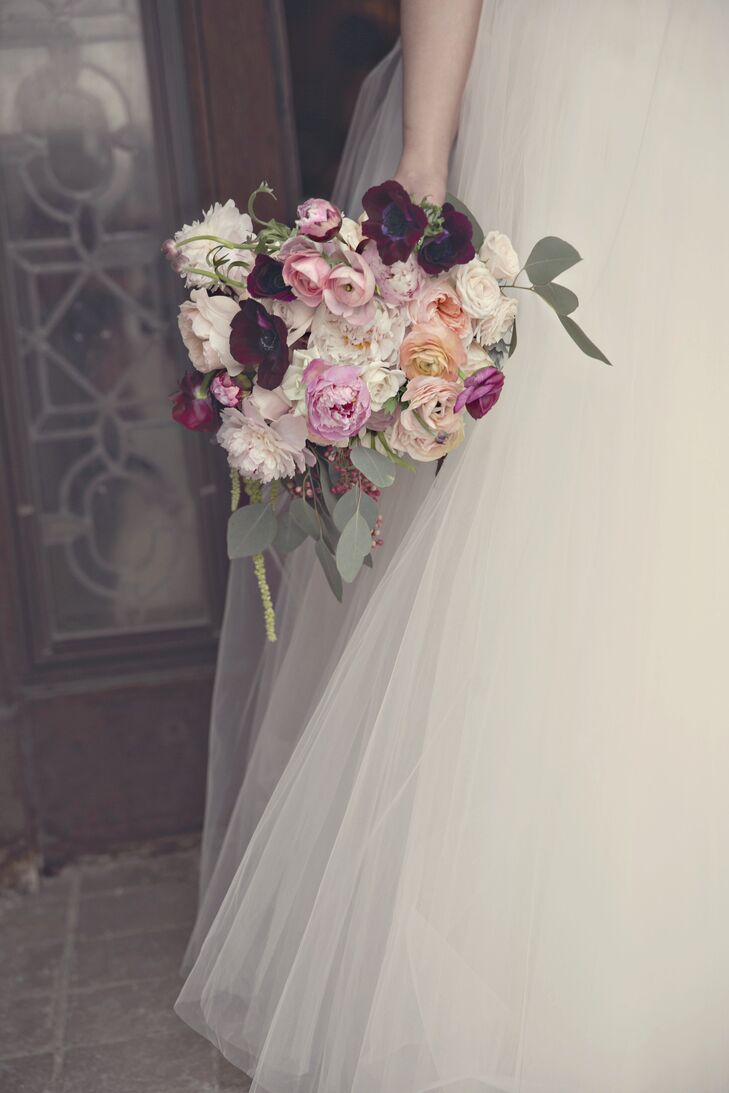 I wanted my bouquet to be very unconstructed and textured with draping pieces, says Emily. Her gathering of peonies, anemones, garden roses and ranunculus was a soft blush color with bold pops of burgundy to match the bridesmaid dresses.