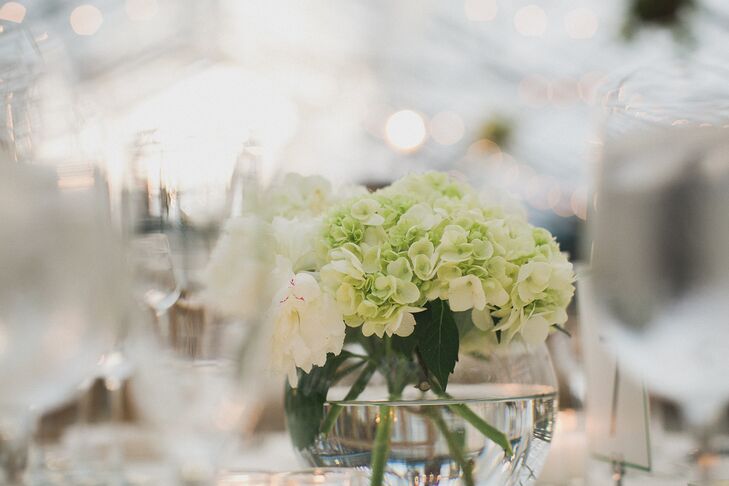 Since there was already so many leafy greens in the reception venue, Nicole and Adam kept their centerpieces simple with small arrangements of viburnum, roses and hydrangeas.