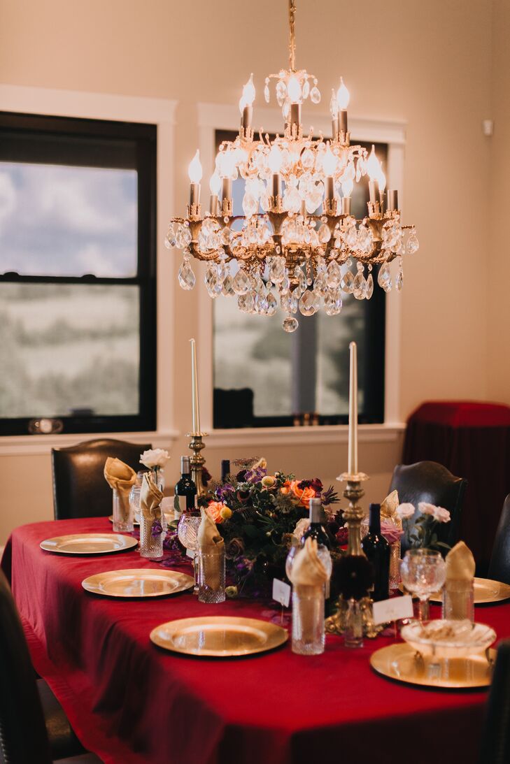 Moody Wedding Reception With Taper Candles and Chandelier