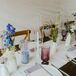 Rustic Table With White Runner, Lavender Napkins, Pastel Candles, Goblets and Colorful Wildflowers
