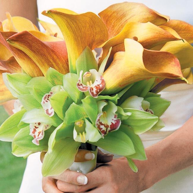 Diane’s bouquet was a bundle of mango calla lilies (for the clean, elegant lines) surrounded by a ring of green orchids (because her father grows orchids) and wrapped with a white satin ribbon.