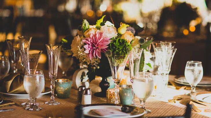 Flower arrangements included small vases of pink dahlias, blush roses, white hydrangeas, thistles and bells of Ireland.