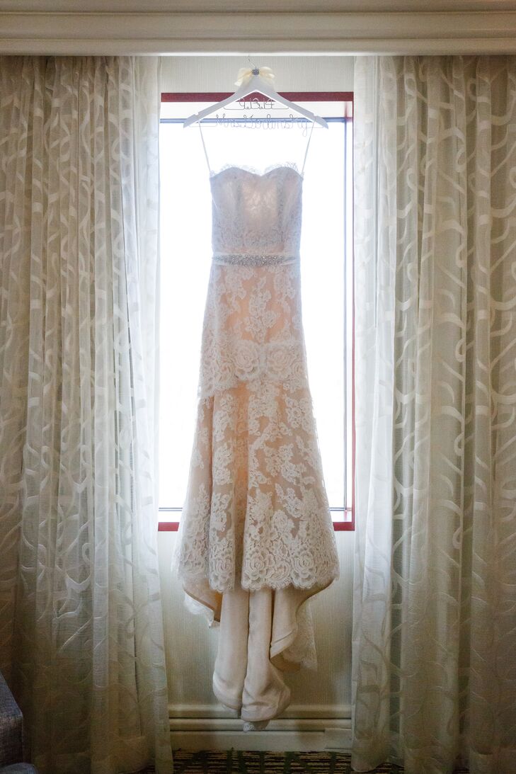 Lisa wore an elegant ivory Anne Barge wedding dress purchased from Nordstrom. The dress was intricately accented with lace and a crystal belt.