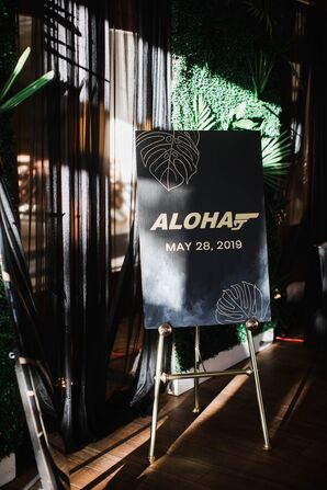 Modern James Bond–Inspired Black Sign with Gold Typography on Easel