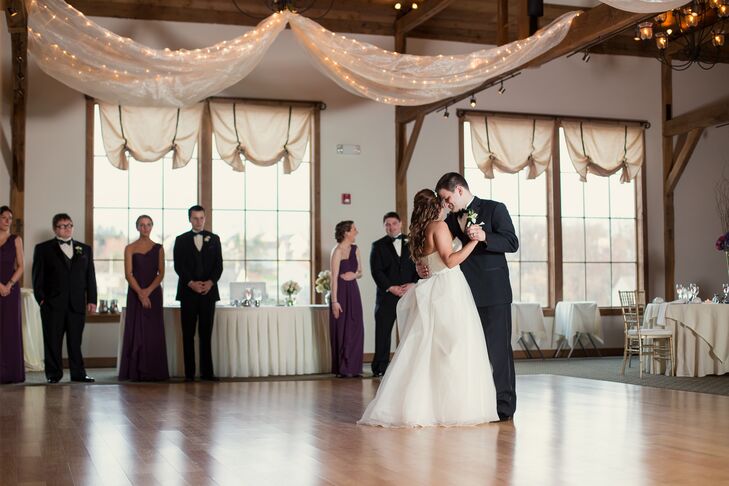 Sarah and Matt added a few fun accents to their reception with white fabric draped along the ceiling, which was covered in string lighting. Each white linen-covered table was also met with a fun hydrangea centerpiece. “The place even had a patio. We had a fire pit there where people could get warm and make s’mores,” Sarah says.