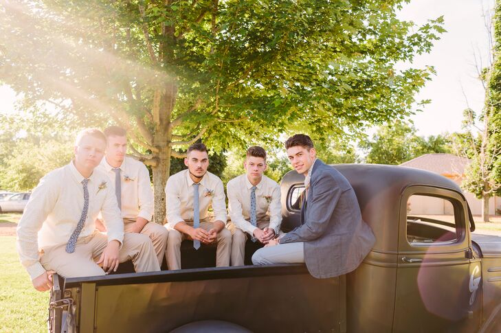 Carson and his groomsmen sat in the back of the black truck, rocking a casual look with a variety of patterned blue ties over ivory collared shirts. Carson stood out among the men with a charcoal gray suit jacket.