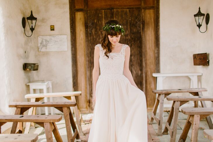 The bride wore a customized gown by Rebecca Schoneveld with a cotton voile skirt and a white bodice fitted with cap sleeves and a natural waistline. Instead of a traditional veil, Kira wore a flower crown with a piece of tulle pinned to her hair.
