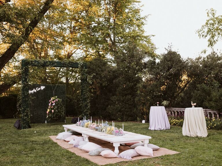 bridal shower dessert table surrounded by pink iridescent balloons