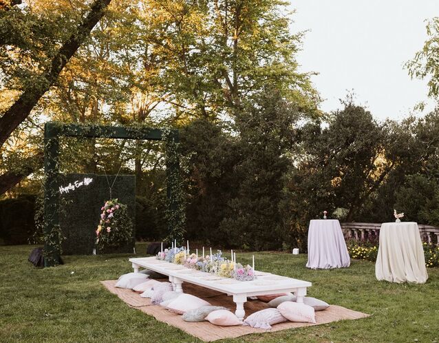 bridal shower dessert table surrounded by pink iridescent balloons