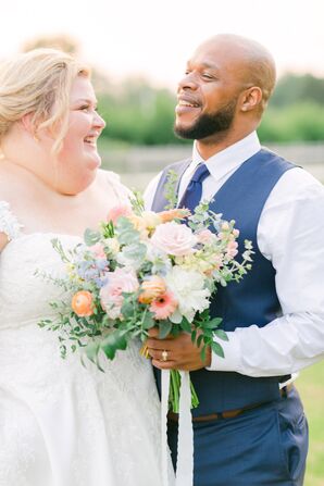 Couple Posing and Holding Bouquet With Stock, Daisies, Ranunculus, Eucalyptus and Roses