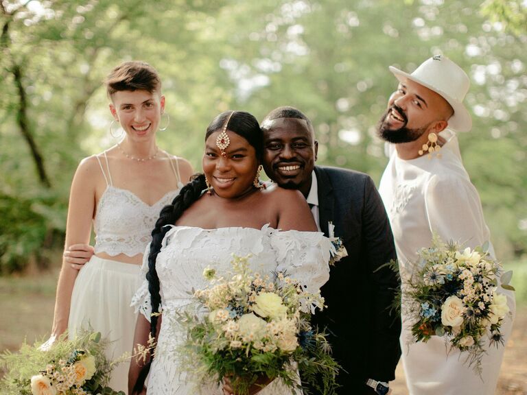 Bride and groom on their wedding day surrounded by loved ones. 