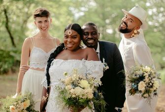 Bride and groom on their wedding day surrounded by loved ones. 