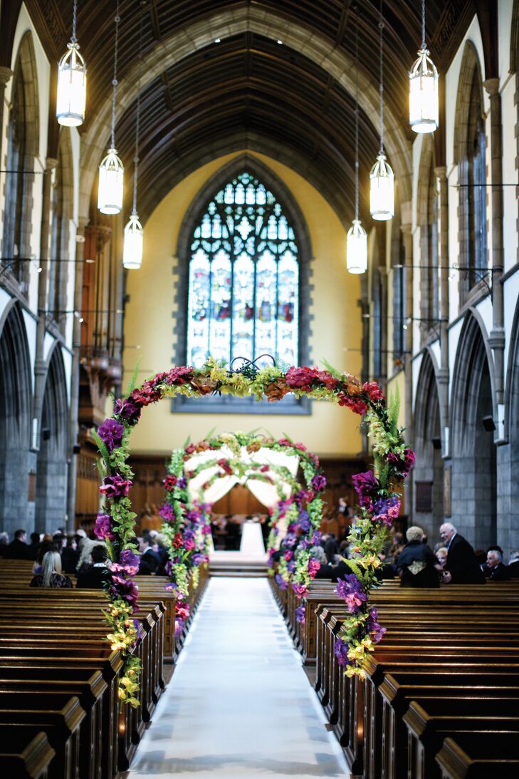 The ceremony took place inside Amasa Stone Chapel in Cleveland, Ohio, where the aisle had archways decorated in blooms and greenery that led all the way up to the altar.