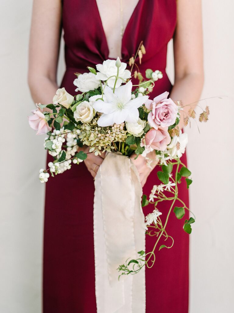 A bridesmaid holds this pale cream and pink bouquet.