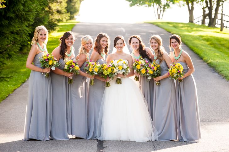 Haley stood in the middle of her bridesmaids, who wore floor-length strapless dresses in heather gray. Each of the women had matching turquoise statement necklaces that added a nice pop of color.