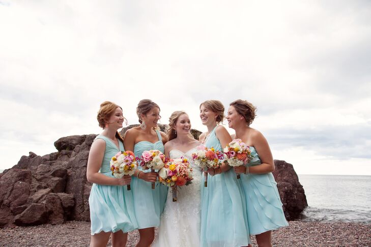 The bridesmaids wore mismatched blue bridesmaid dresses with simple updos.