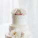 Wedding Cake With Floral and Fabric Details