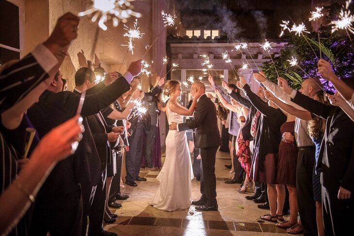 After a night of fun noise makers, sampling a metallic four-tier wedding cake and snapping pictures in a photo booth, Irina and Richard started the New Year with a festive sparker exit. The couple were surrounded by 122 friends and family members as they shared a kiss under the glow of sparklers.