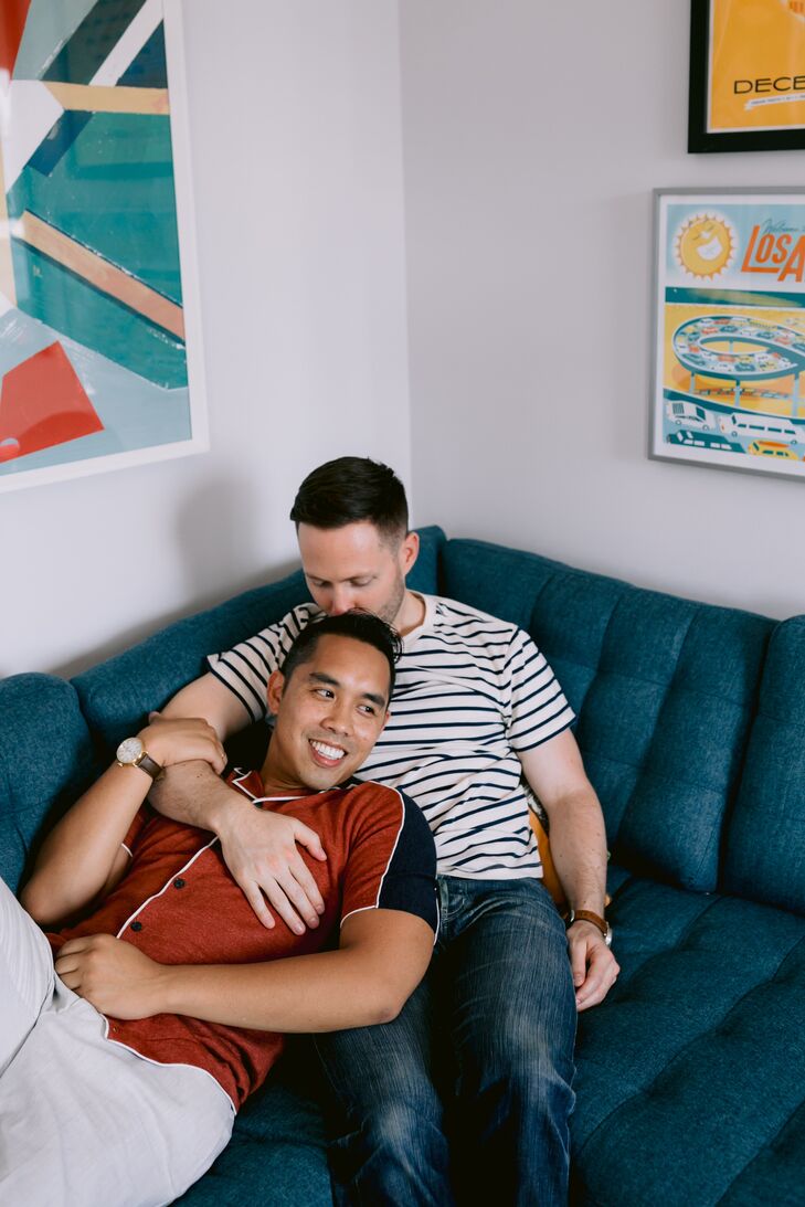 Grooms Lounging on Couch at Home for Engagement Photos