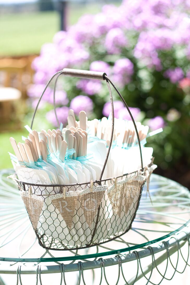 Jen handmade the ceremony programs which doubled as fans, perfect for a sunny summer day in California, and were set in a rustic wire basket with burlap lace bunting.