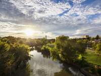 The sun rises over a gorgeous river landscape