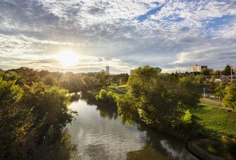 The sun rises over a gorgeous river landscape