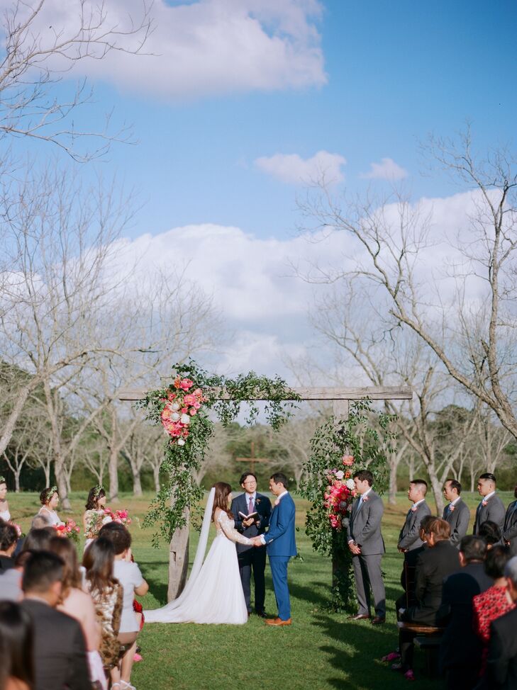 Deborah and Elton chose Chandelier Grove in Tomball, Texas, the site of the ceremony and reception, for its Southern charm. The couple said their vows under a flower arch amid blossoming bluebonnets in a pecan grove.