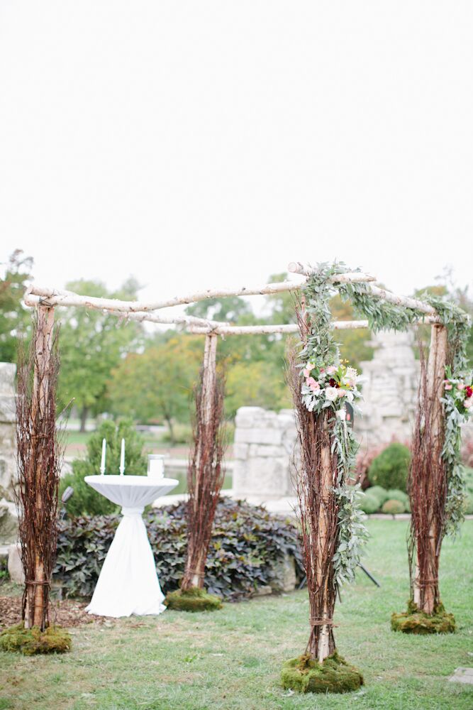 Jessica and Bassey exchanged vows at the ruins in Tower Grove Park in St. Louis, Missouri. Since the location was gorgeous on its own, the couple kept their decor natural and organic. Their chuppah was made of unfinished tree branches adorned with olive branches, garden roses and leafy garlands.