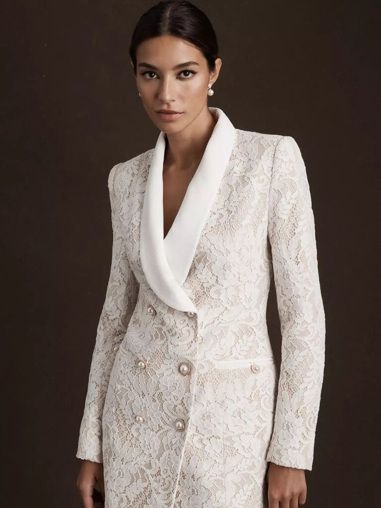 Model wears lace oversized blazer with pearl buttons. 