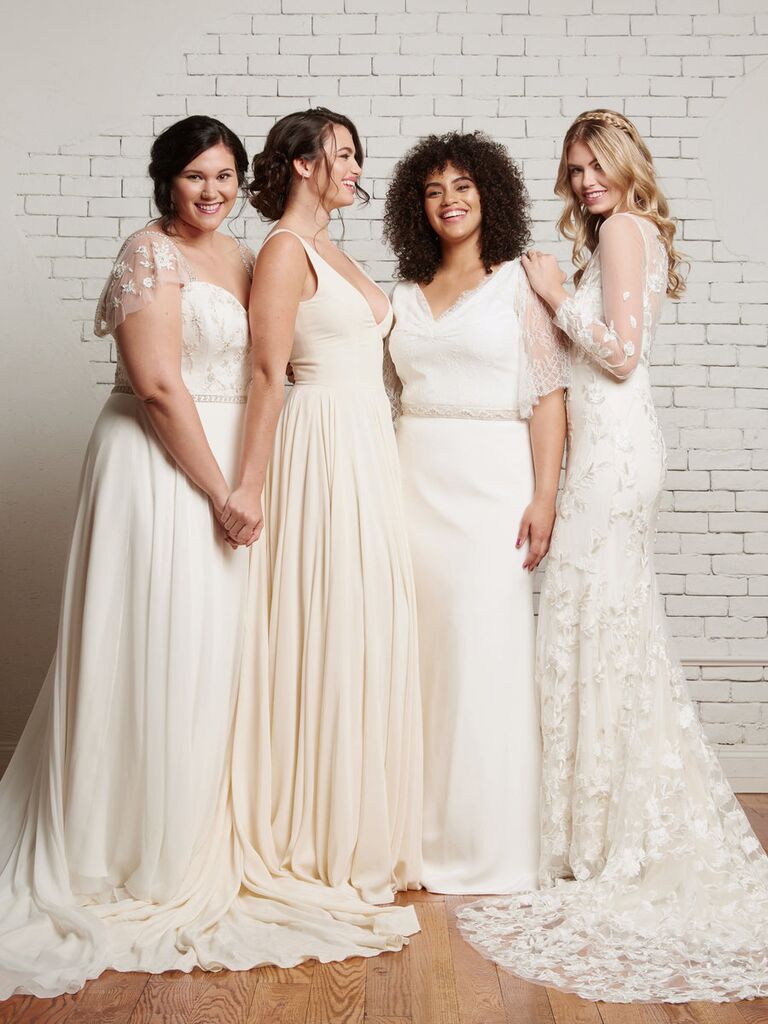 Four models pose in beautiful wedding dresses. 