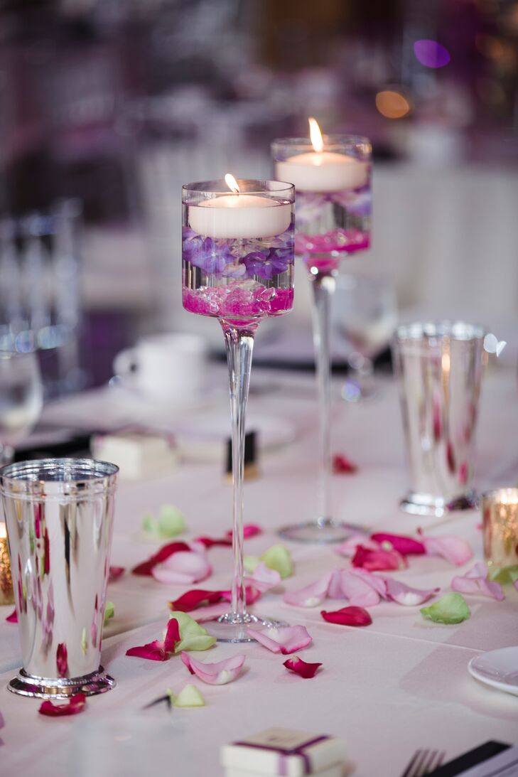 Some of the reception tables at A'Bulae in St. Paul, Minnesota, were topped with floating candles filled with purple orchids under the water. Rhinestones, mercury glass and fresh rose petals brought the look together.
