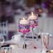 Some of the reception tables at A'Bulae in St. Paul, Minnesota, were topped with floating candles filled with purple orchids under the water. Rhinestones, mercury glass and fresh rose petals brought the look together.