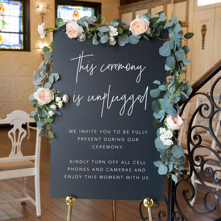 Black-and-white sign with eucalyptus garland