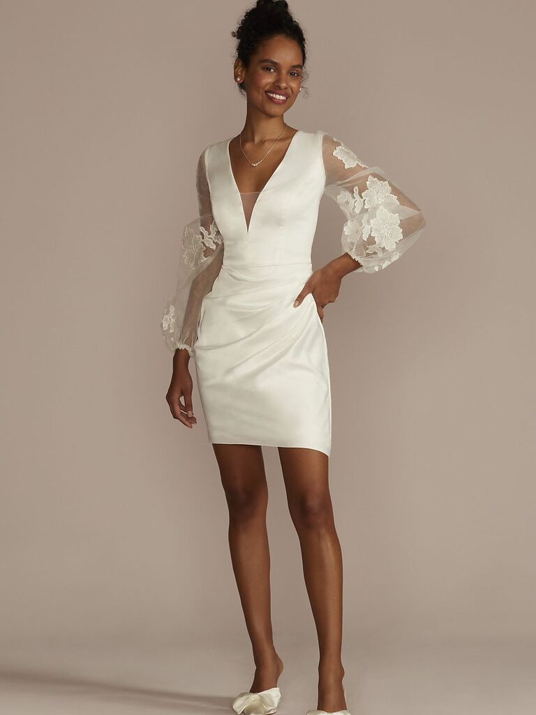 Model wears a short dress with puffed sleeves. 