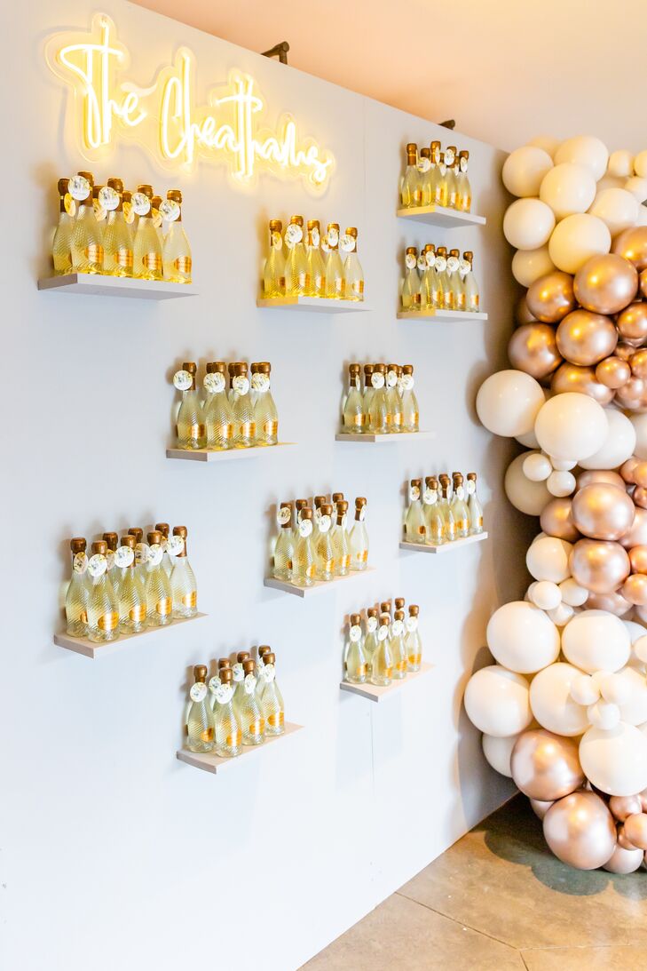 Escort Card Display With Small Bottles of Champagne