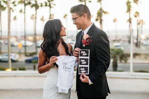 Couple With Onesie For Pregnancy Announcement