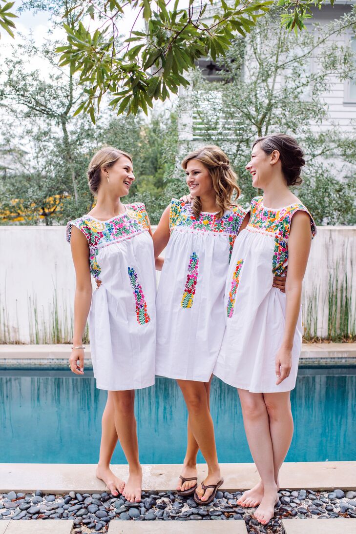 Caroline and Christopher had a large wedding party, but her sisters stood out before and during the wedding. They all got ready together in floral baby-doll dresses with mosaic-inspired patterns along the high neckline. Later, the bridesmaids switched out their looks for navy dresses.