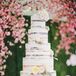 Despite the other small goodies served throughout the day, nothing compared with the five-tier naked cake dusted with white and accented with fresh blooms. The entire dessert stood on top of a simple white stand.