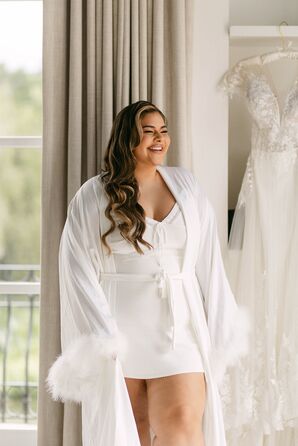 Bride in White Mini Dress, White Robe and Glam Makeup Getting Ready