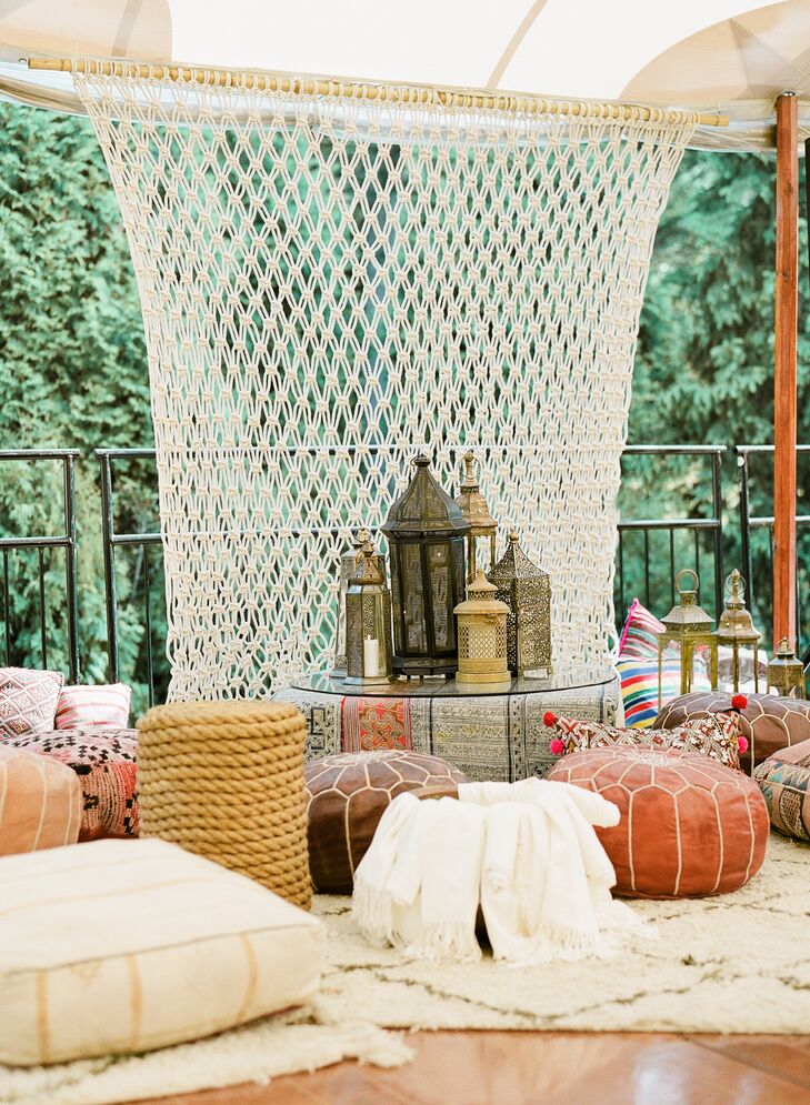 Lounges with a Hookah pipe, antique sofas, Moroccan rugs, lanterns, woven pillows and ottomans were set up inside and outside of the reception tent.