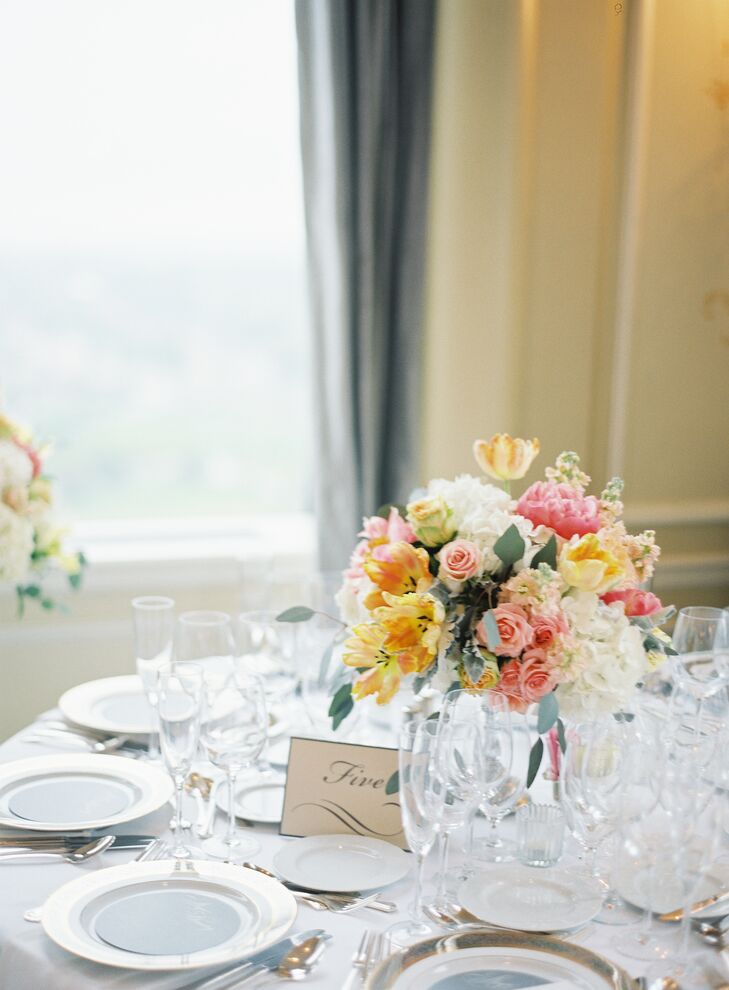 Alyse and Dimitry’s wedding day was all about fusing the cheerfulness of spring with timeless elegance. Working with Katie Saeger Events and The Special Event Florist, the couple took the Saint Louis Club’s refined interiors to the next level, dressing the reception tables with vibrant bunches of hydrangeas, stock, tulips, dusty miller, peonies and roses in eye-catching peach, yellow, coral and pink hues.