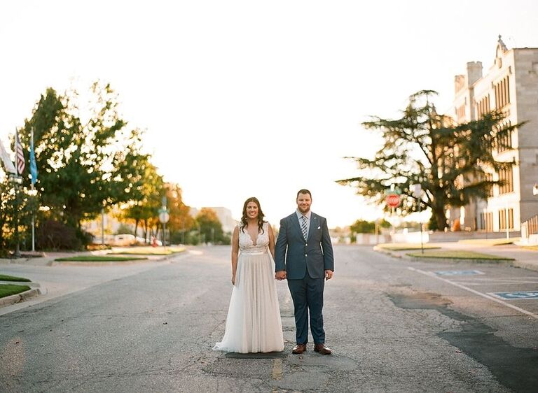 bride and groom holding hands on street Oklahoma City