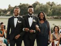 Parents walking son down the aisle 