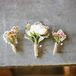 Spray roses, wax flowers and dusty miller loosely wrapped in twin had a natural look.