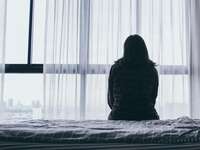 Woman alone looking out the window.