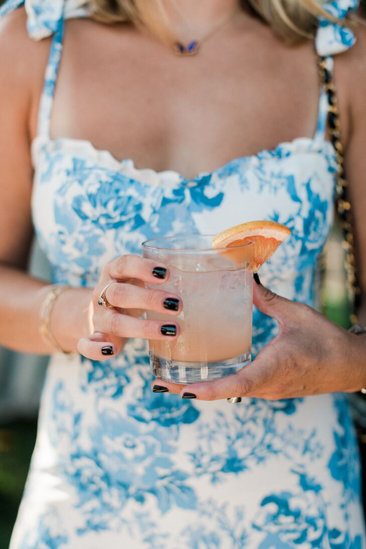 Woman Holds Signature Drink, a Refreshing Paloma, at Summer Wedding