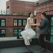 Couple Jumping and Holding Hands During Reception at The Line Hotel in Washington, DC