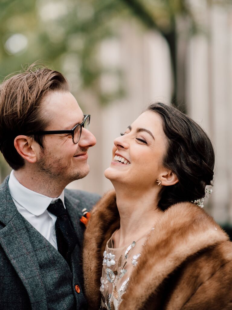 A woman and man laugh together in a close-up for their engagement photoshoot