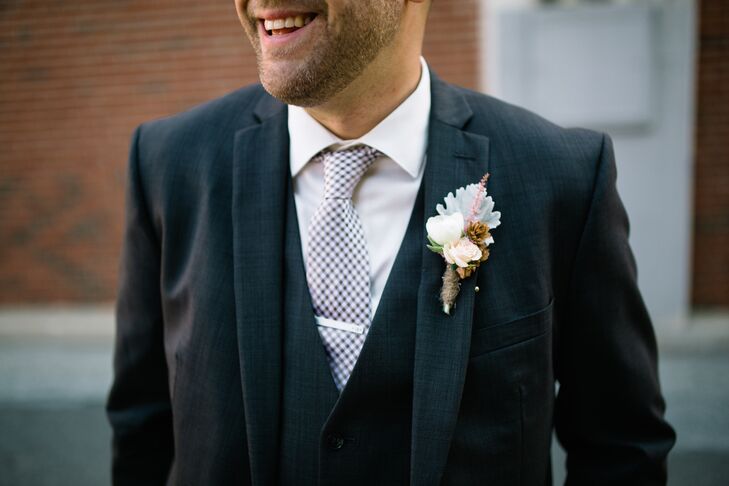 To stand out from his groomsmen, Matthew wore a vest of the same fabric as his charcoal suit from Macy's.